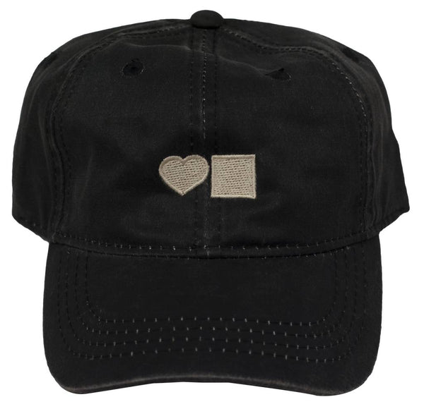 A BLUETILE WAXED CANVAS DAD HAT BLACK with a heart on it by Bluetile Skateboards.