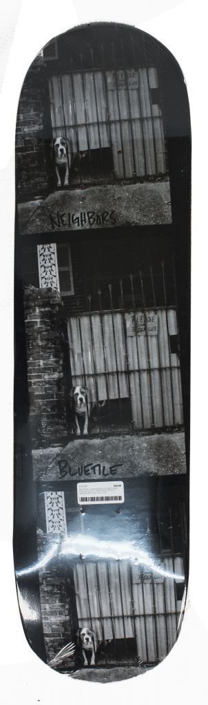 A black and white photo of a BLUETILE X NEIGHBORS DOG note.