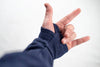 A person making a hand gesture with a Bluetile Skateboards BLUETILE LOVE BLUETILE PREMIUM HOODIE.