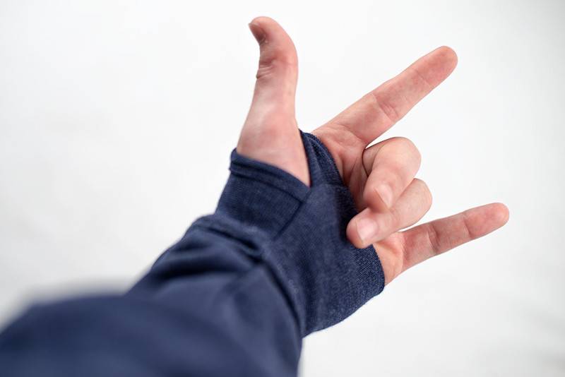 A person making a hand gesture with a Bluetile Skateboards BLUETILE LOVE BLUETILE PREMIUM HOODIE.