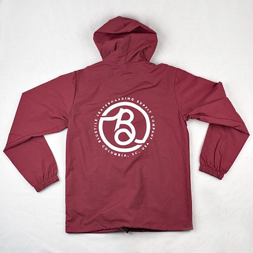 A Bluetile Skateboards BLUETILE SUPPLY CO HOODED COACHES JACKET (BURGUNDY) with a white logo on it.