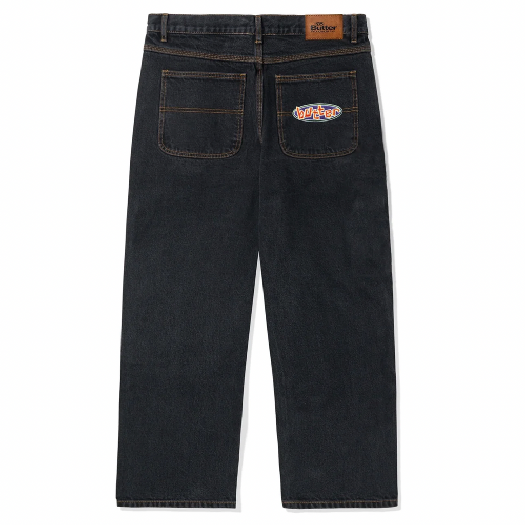A picture of a pair of Butter Goods Scattered Denim Pants in Dark Indigo.