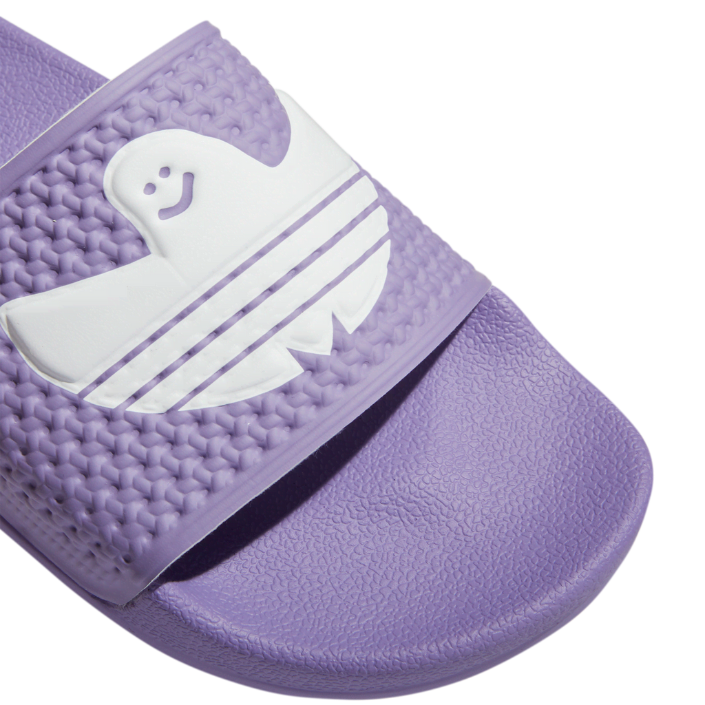 An Adidas Shmoofoil Slide Lilac/White with a white ghost on it.