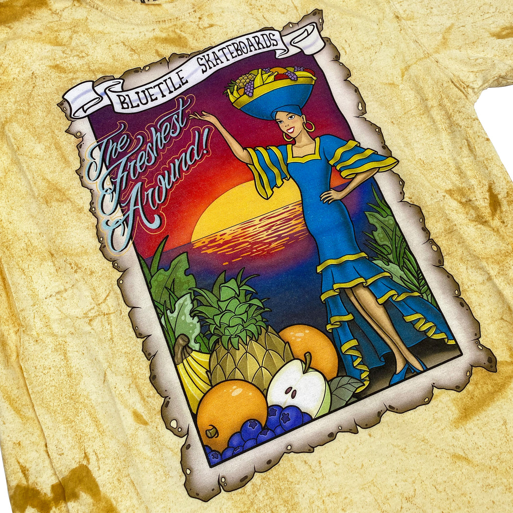 A yellow tie dye t-shirt with an image of a woman and fruit from the 420 COLLECTION featuring the Bluetile Skateboards BLUETILE TROPIC DAZE TEE CITRINE design.