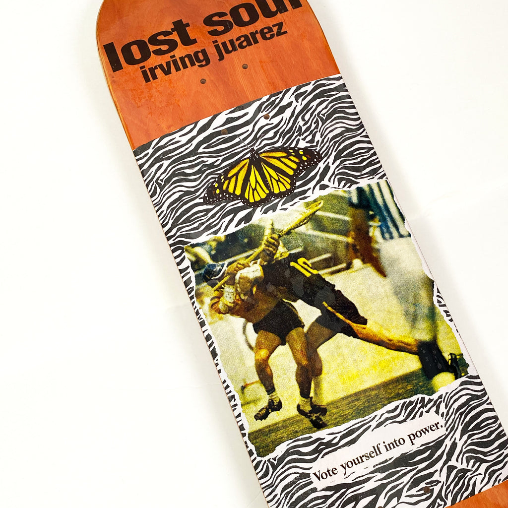 A close up of a Lost Soul Skateboards' IRVING JUAREZ SMASHING MODEMS skateboard on a white surface.