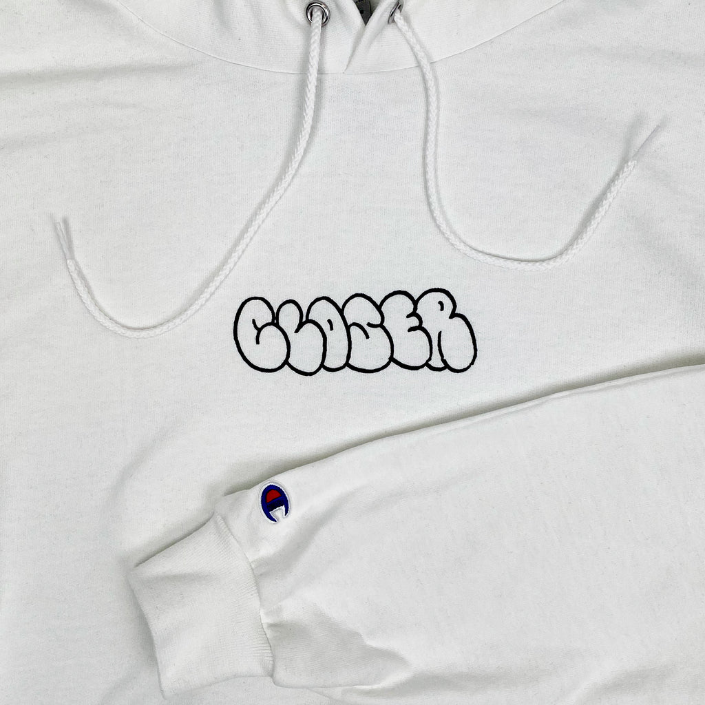 A CLOSER X MIKE GIGLIOTTI BUBBLE HOODIE WHITE with a black and white logo on it.
