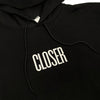 A close up of a CLOSER MAG HOODIE BLACK with the word CLOSER printed on it.