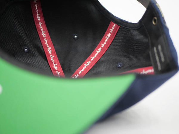 The photo shows the inside of a CHOCOLATE CHUNK OF COLUMBIA HAT by CHOCOLATE, featuring red internal taping with repeating white "chocolate" text.