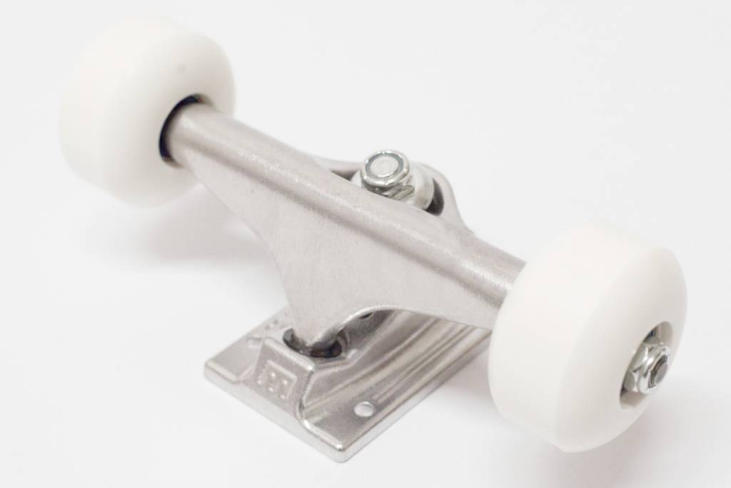 A white ROYAL skateboard wheel on a bluetile blank surface.