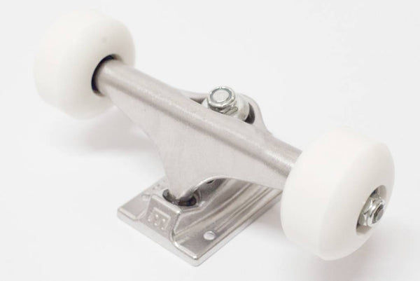 A white ROYAL skateboard wheel on a bluetile blank surface.
