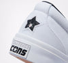 A white CONVERSE CONS ONE STAR CC SLIP WHITE / BLACK / WHITE sneaker with a spider logo on it.