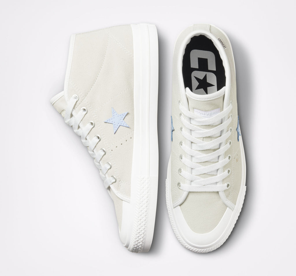 A pair of white CONVERSE CONS ONE STAR PRO MID ALEXIS VINTAGE WHITE / WHITE sneakers with a blue star on them.