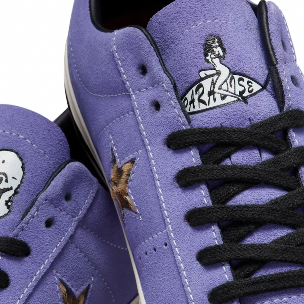 A pair of CONVERSE CONS X PARADISE SEAN PABLO ONE STAR PRO OX WILD LILAC sneakers with skulls on them.