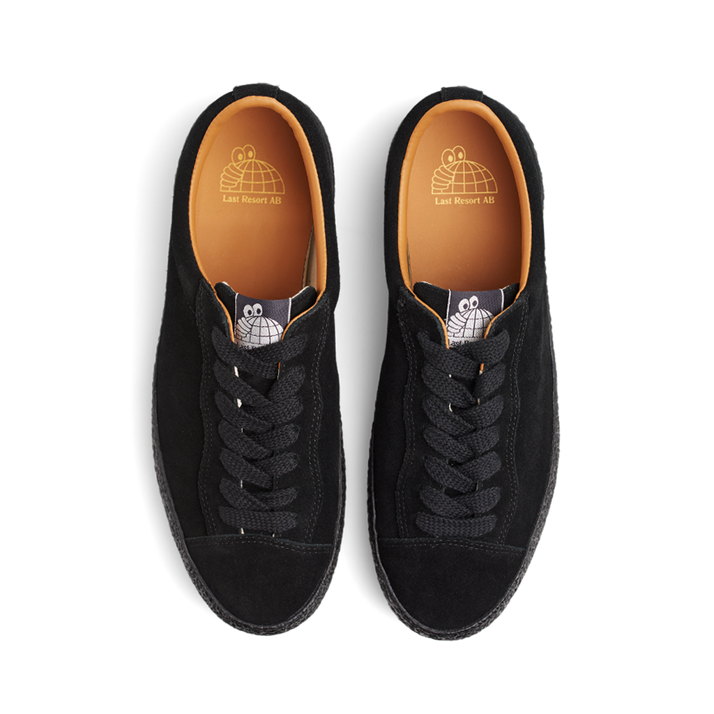A pair of LAST RESORT AB VM002 SUEDE LO BLACK/BLACK sneakers with orange soles, designed by Last Resort AB.
