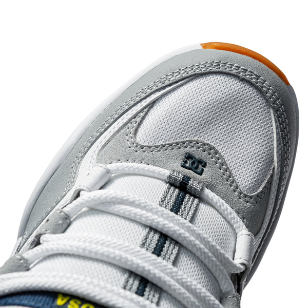A close up of a white and orange DC KALIS OG WHITE/GREY shoe.