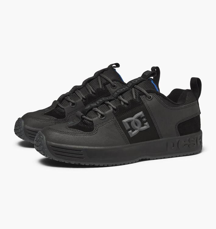 A pair of black DC Lynx OG Black/Grey shoes with blue and black accents.