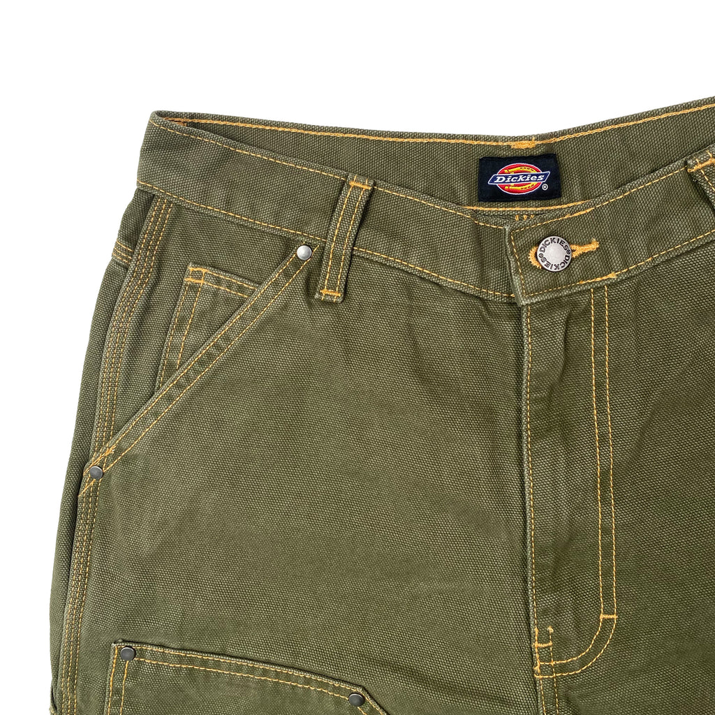 A close up of a pair of DICKIES DOUBLE KNEE DUCK CANVAS PANT in Stonewashed Green/Nugget.