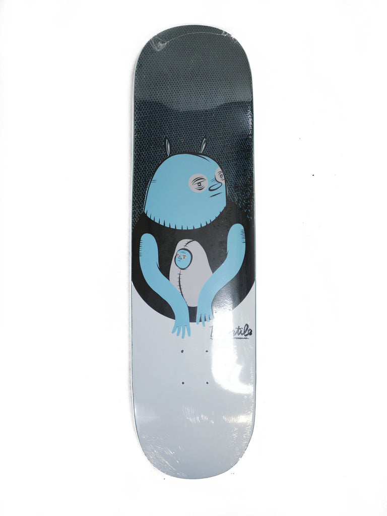 A skateboard with a BLUETILE BABY BLUE image of an alien on it. (Brand Name: Bluetile Skateboards)