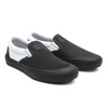 A pair of black and white slip on shoes.