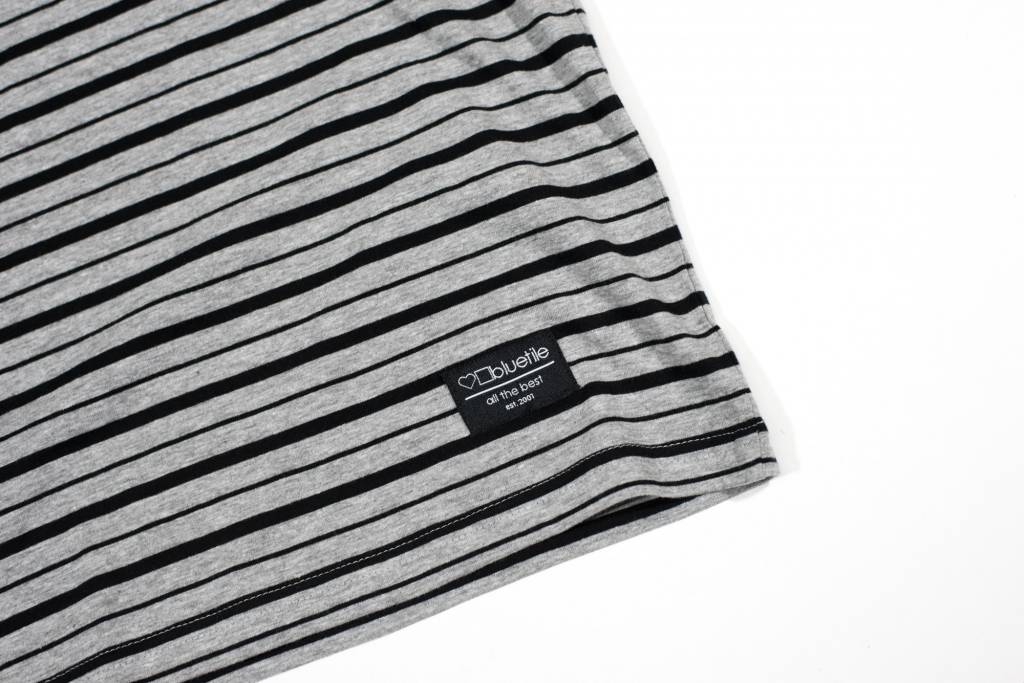 A soft and high-quality Bluetile Surplus Striped Tee Grey / Black t-shirt on a white surface, by Bluetile Skateboards.