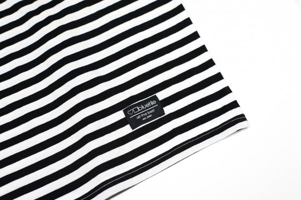 A Bluetile Skateboards BLUETILE SURPLUS STRIPED TEE BLACK / WHITE on a soft white surface.
