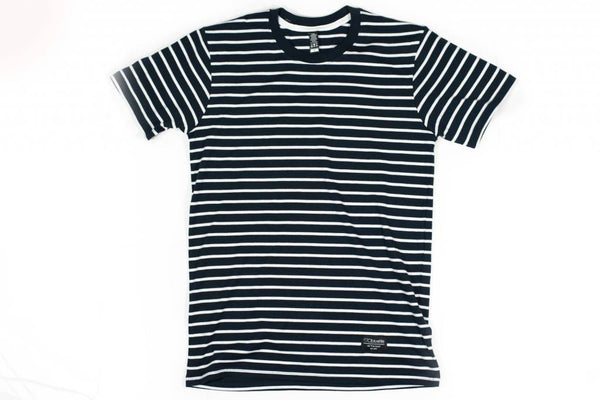 A soft BLUETILE SURPLUS STRIPED TEE NAVY / WHITE t-shirt on a white background from Bluetile Skateboards.