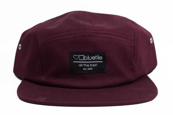 An adjustable garnet Bluetile Skateboards five-panel hat with a Bluetile Skateboards label on it.