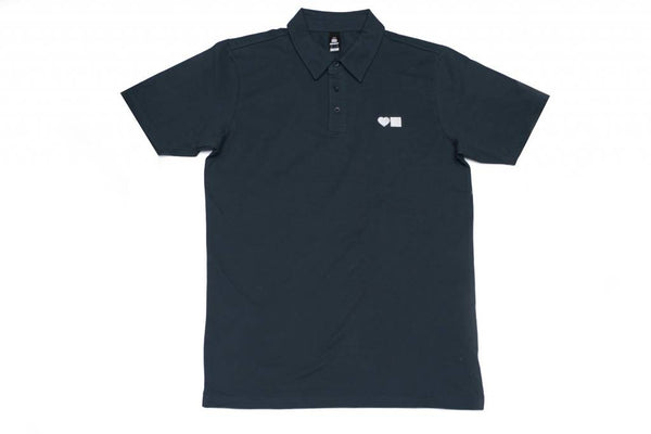 A BLUETILE SURPLUS LOVE BLUETILE POLO NAVY / WHITE shirt from Bluetile Skateboards with a white logo on it.