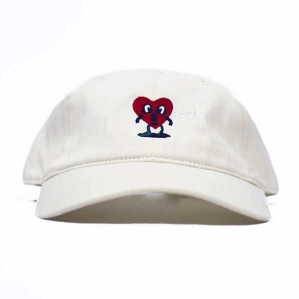 A BLUETILE PUFF HEART DAD HAT CREAM with a heart embroidered on it, also known as a Bluetile Skateboards Dad Hat.