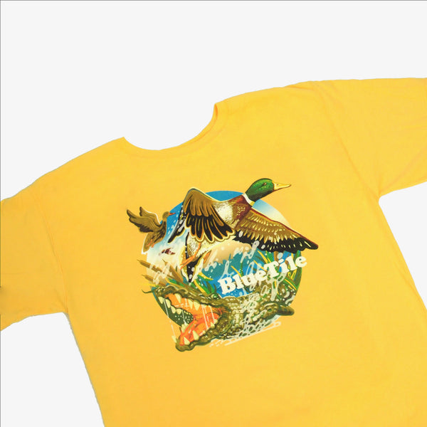 A BLUETILE WILDERNESS DUCKS T-SHIRT SUNNY YELLOW by Bluetile Skateboards with an image of a duck and a crocodile.