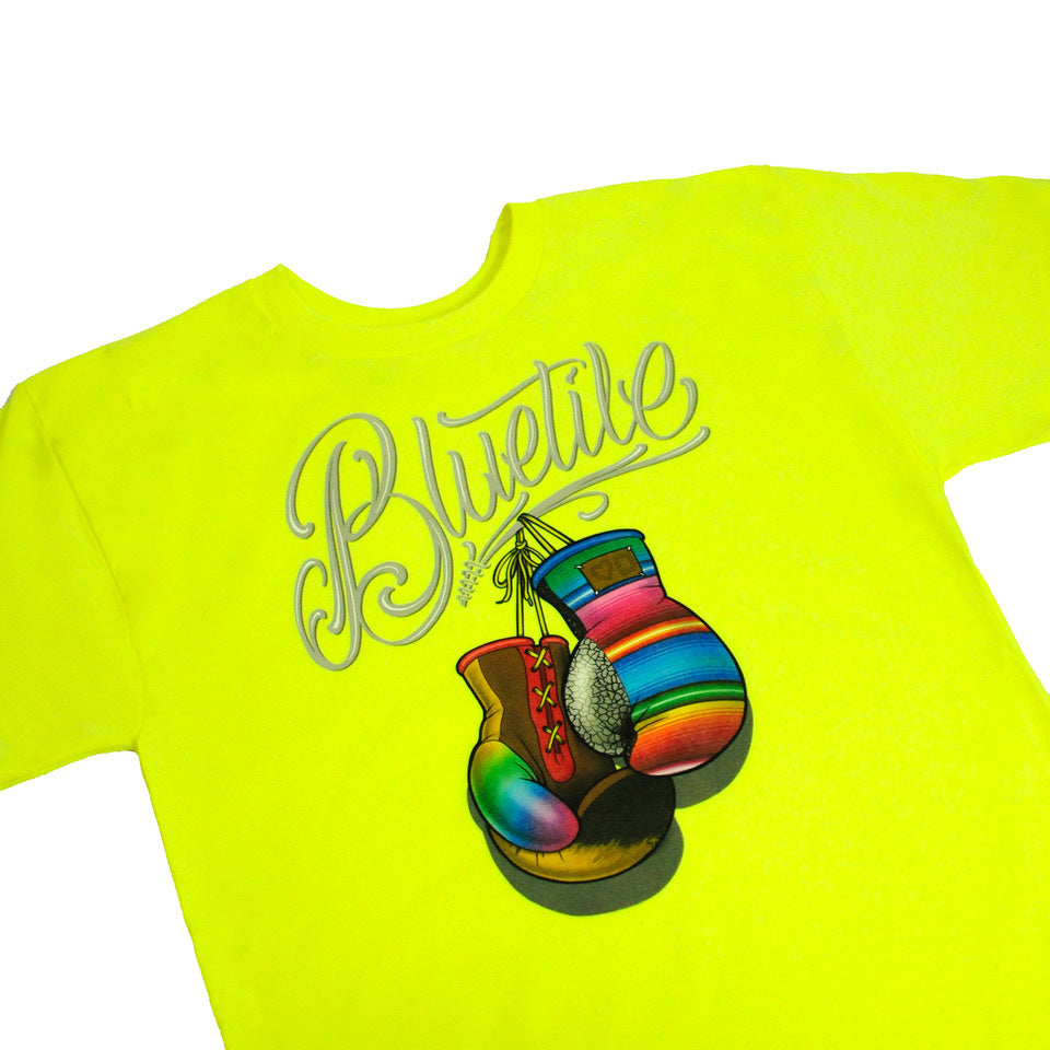 A Bluetile Skateboards BLUETILE BOXING CLUB T-SHIRT SAFETY GREEN with a boxing glove on it.