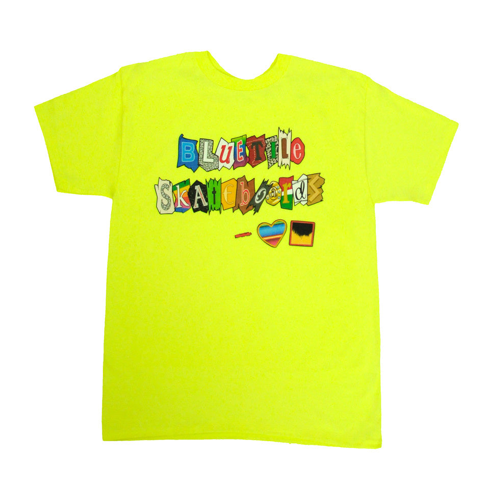 A yellow BLUETILE SKATEBOARDS RANSOM T-SHIRT SAFETY GREEN with a colorful design on it, sponsored by Bluetile Skateboards.