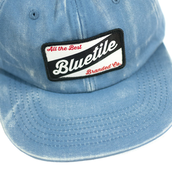 A BLUETILE CRAFT PATCH HAT FADED DENIM with the brand name Bluetile Skateboards on it.