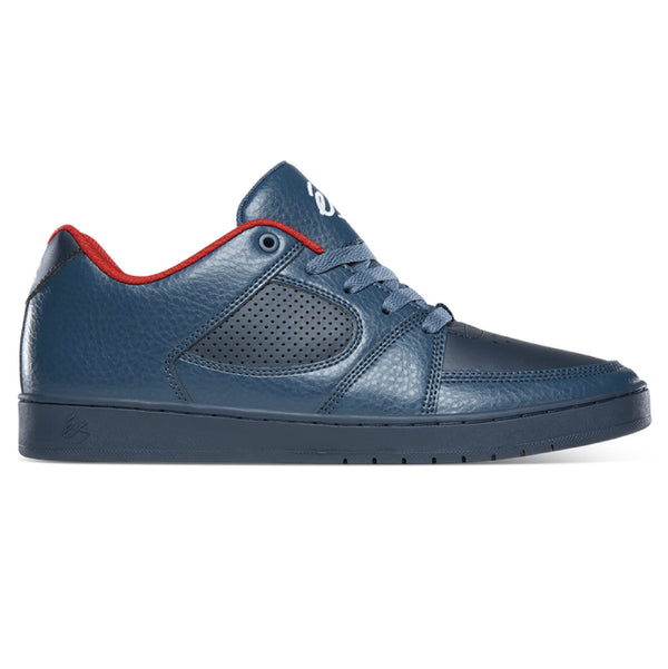 A leather navy shoe with a red accent.