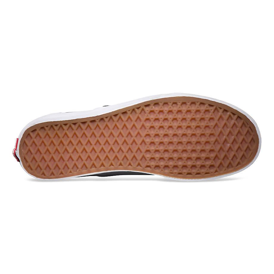 A pair of VANS Classic Slip-On Black/White Checkerboard shoes with a brown sole.