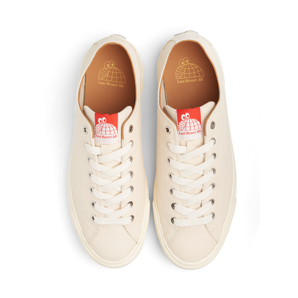 A pair of LAST RESORT AB VM003 CANVAS WHITE/WHITE sneakers on a black background.