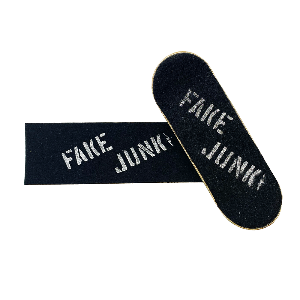 A pair of FAKE JUNK skateboards with the words "fake junk" on them featuring chrome accents.