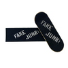A pair of FAKE JUNK skateboards with the words "fake junk" on them featuring chrome accents.