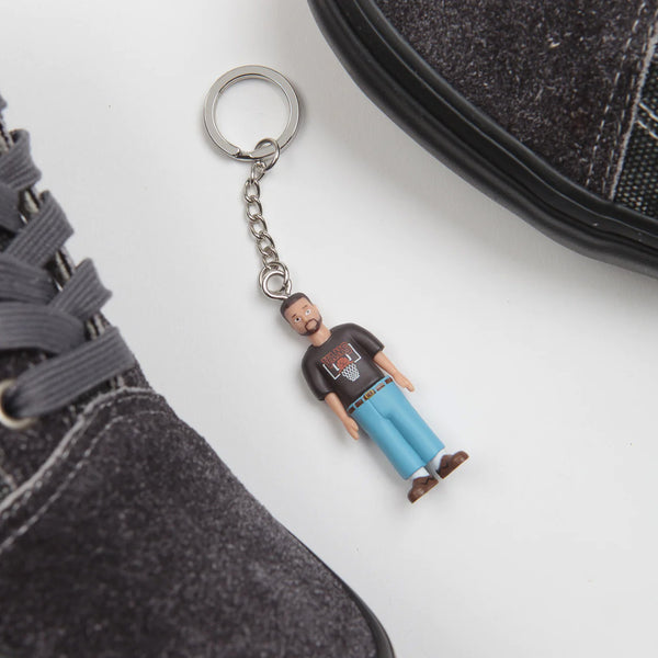 a keychain with a picture of a man wearing VANS SKATE X QUASI OLD SKOOL ASPHALT on it.