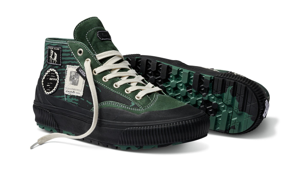 A pair of VANS X FORMER DESTRUCT MID MTE GREEN sneakers with white laces.