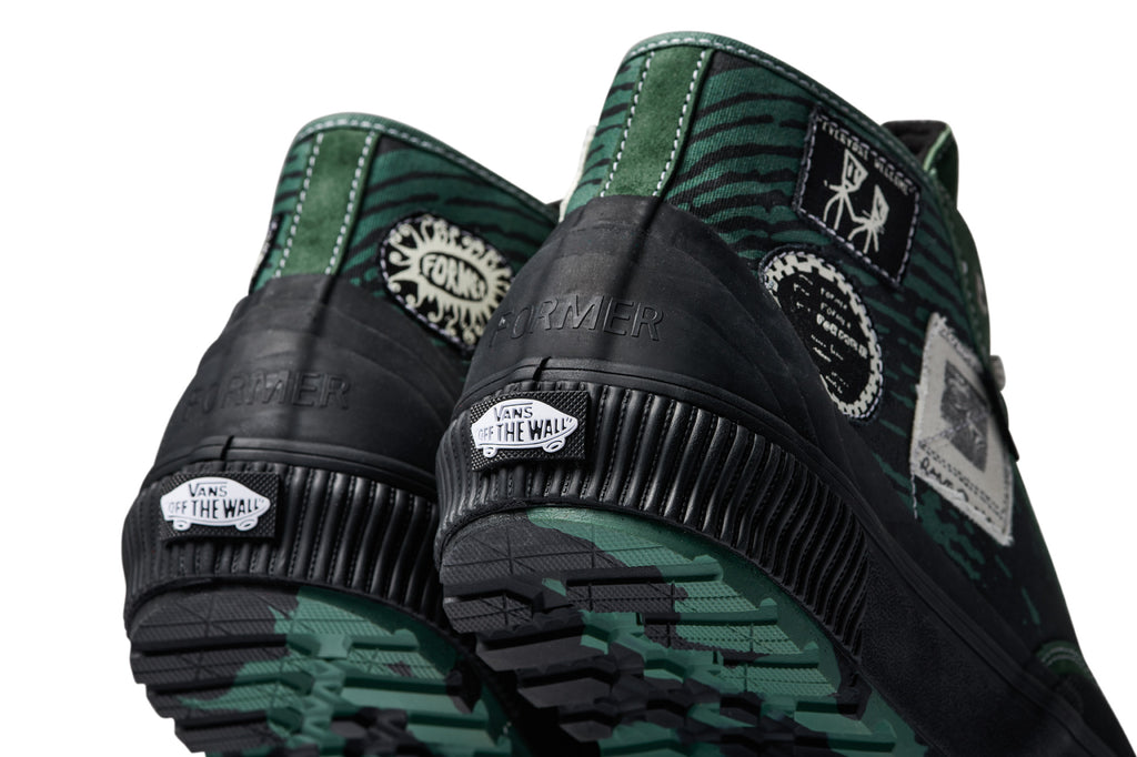 A pair of VANS X FORMER DESTRUCT MID MTE GREEN shoes with a white background.