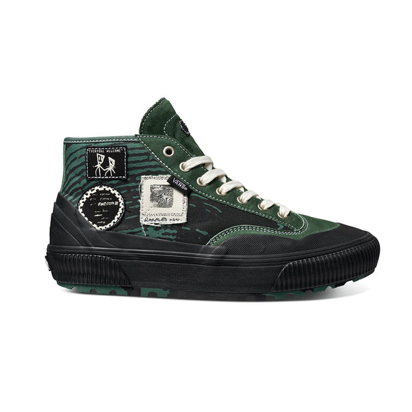 A black and VANS X FORMER DESTRUCT MID MTE GREEN high top sneaker.