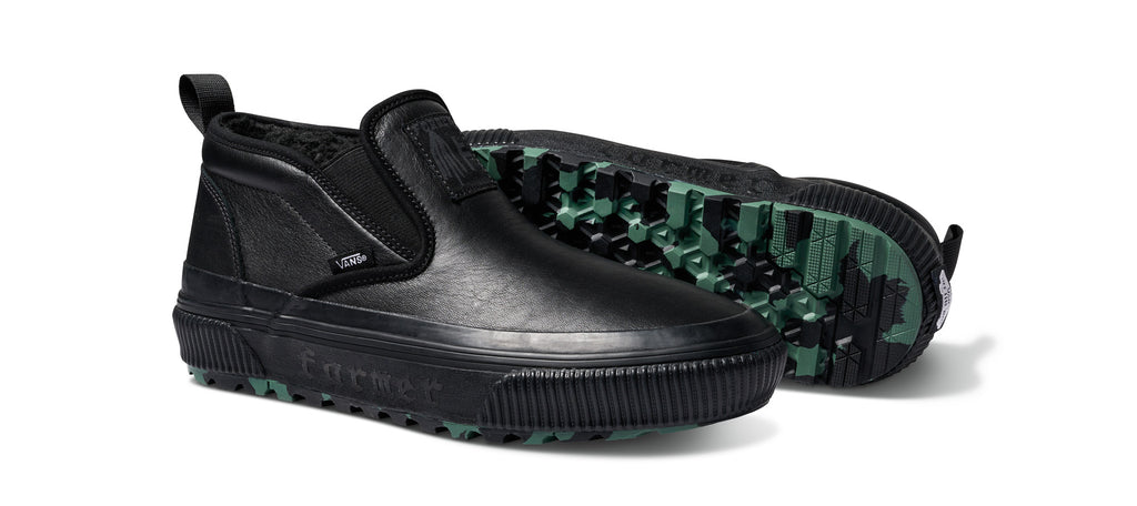 A pair of VANS X FORMER Mid Slip MTE BLACK / GREEN boots with green soles.