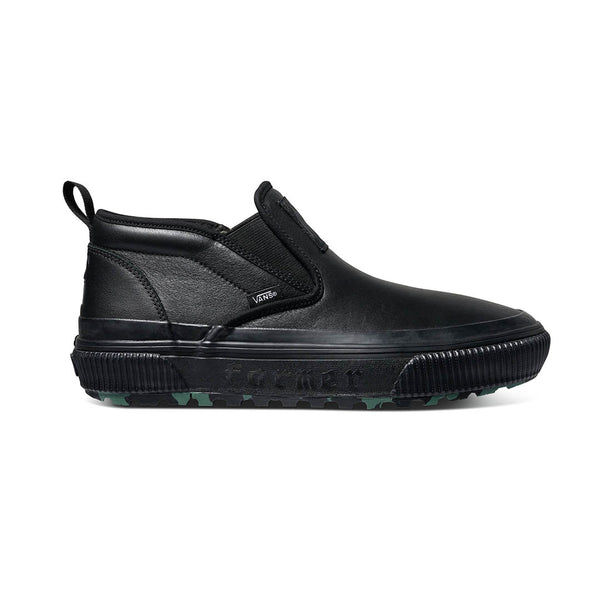 A VANS X FORMER MID SLIP MTE BLACK / GREEN slip on sneaker with green soles.