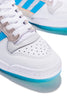 A pair of white ADIDAS DIEGO FORUM 84 MID ADV CHALK WHITE / CLOUD WHITE sneakers with blue accents.