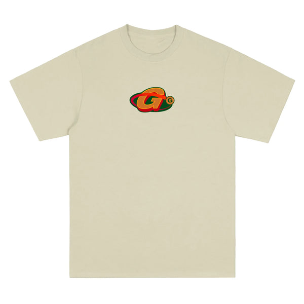 The GAS GIANTS Orbit Tee Sand is a sand-colored T-shirt featuring a vibrant logo with overlapping "G" letters in the center.