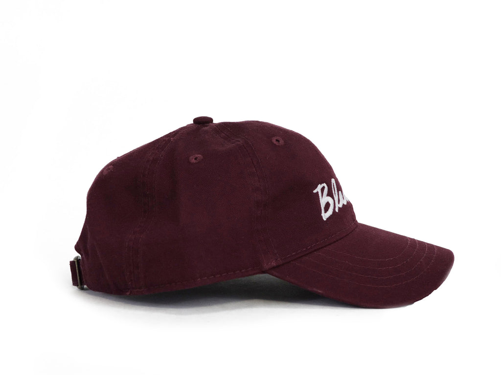 A BLUETILE CURSIVE DAD HAT MAROON with the word blb in CURSIVE on it by Bluetile Skateboards.