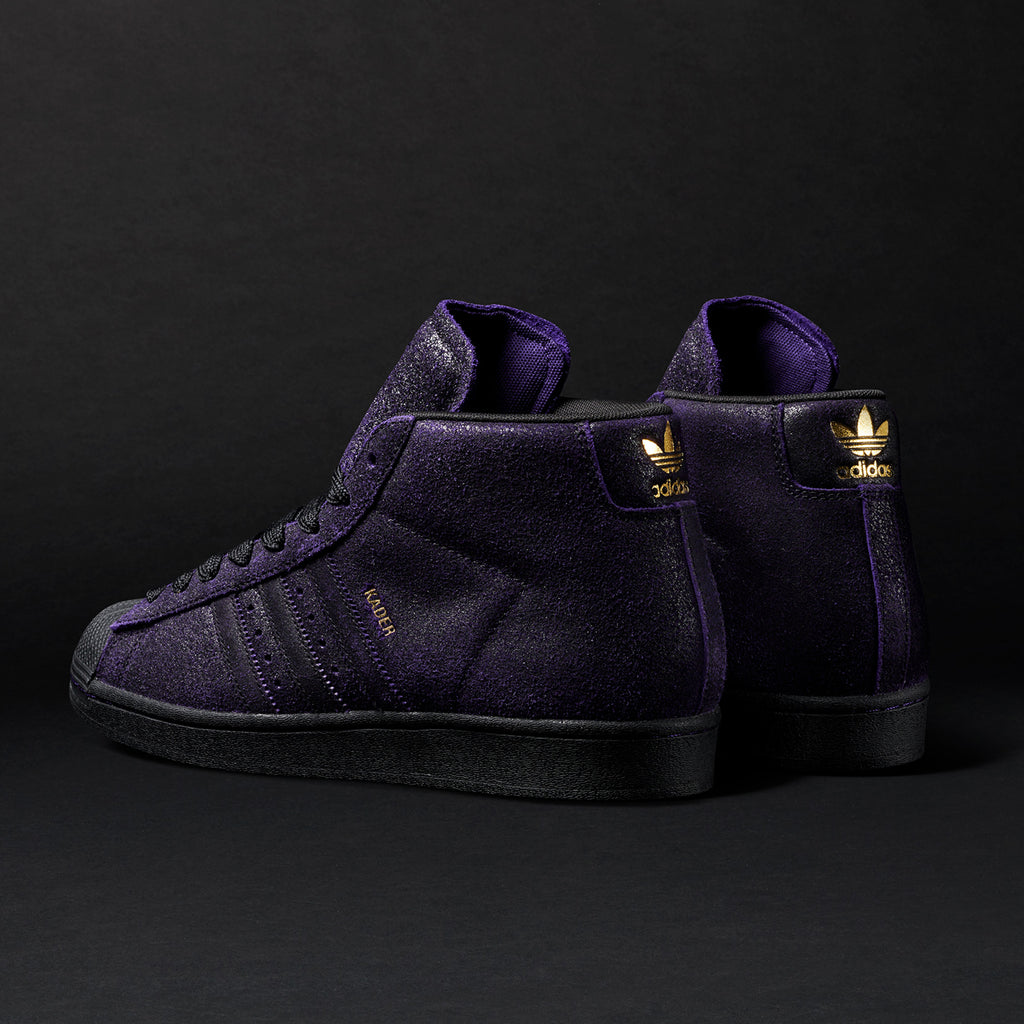 A pair of dark purple ADIDAS KADER SYLLA PRO MODEL ADV sneakers on a black background.