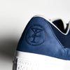 A CONVERSE CONS X ALLTIMERS ONE STAR PRO MIDNIGHT NAVY sneaker with a martini on the side.