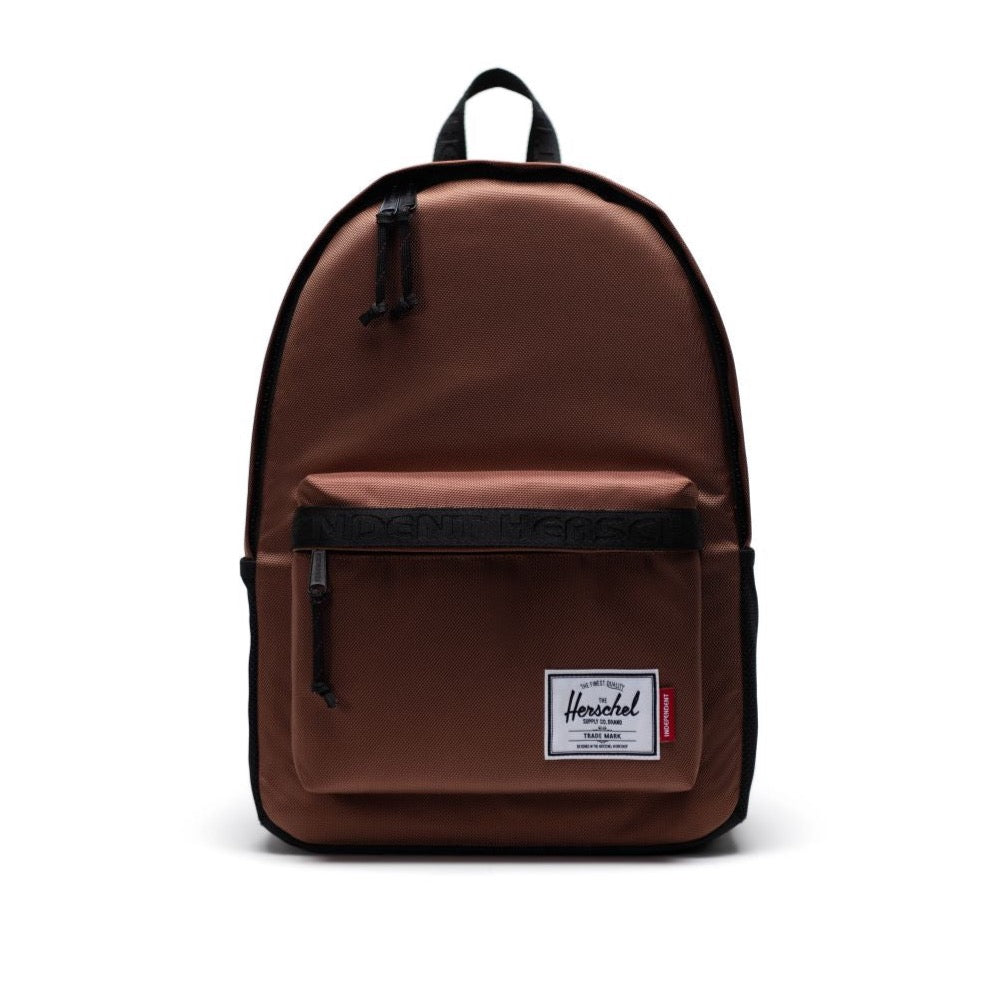 a brown backpack with black straps and a white logo on the front left